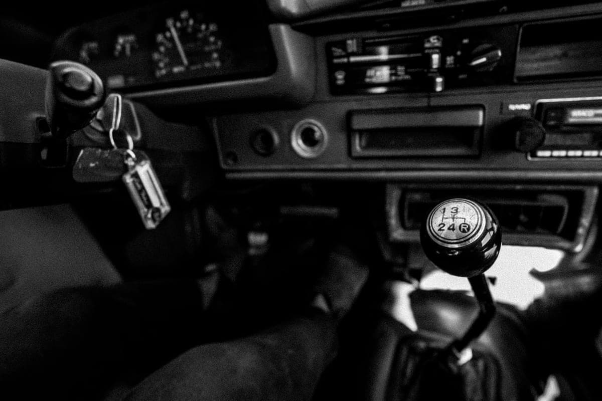 Coins and keys resting on a car seat