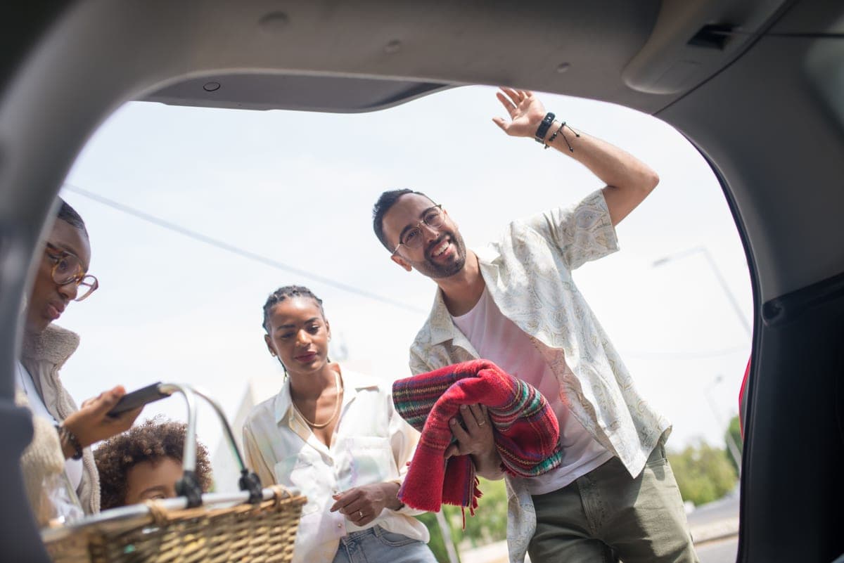 A parent loading a child into a car
