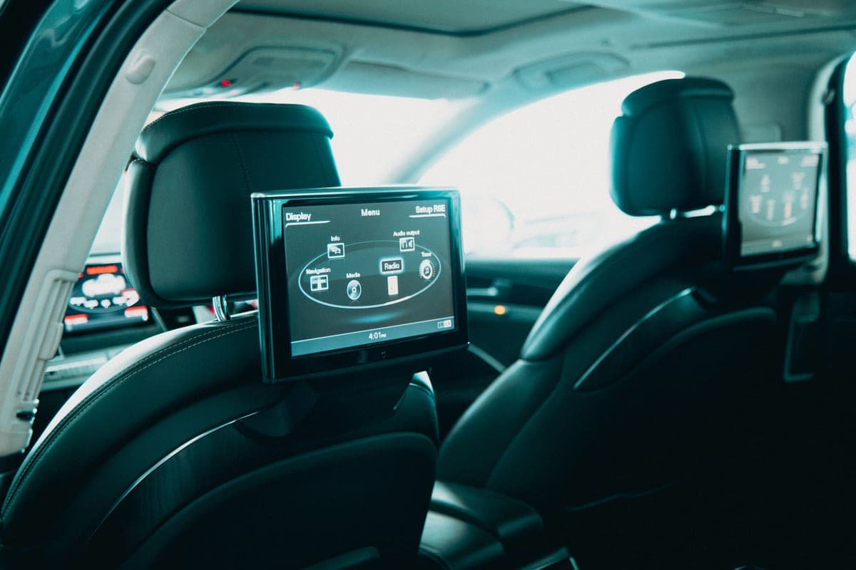 A tablet screen in the back seat of a car
