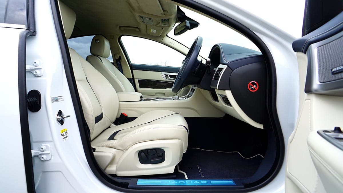 The footwell and floor mat of an SUV interior