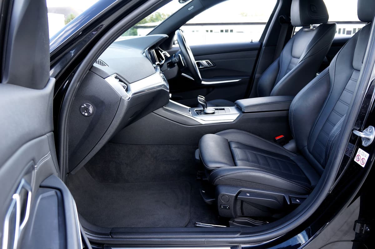 The front passenger seat of a car with a bag on it
