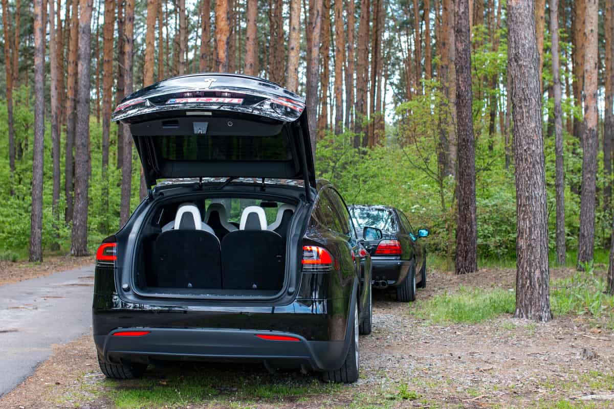 An SUV with its rear hatch open, showing the back of the rear seats facing the cargo area