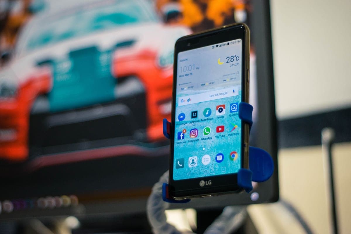 An Android phone held on a car dashboard mount