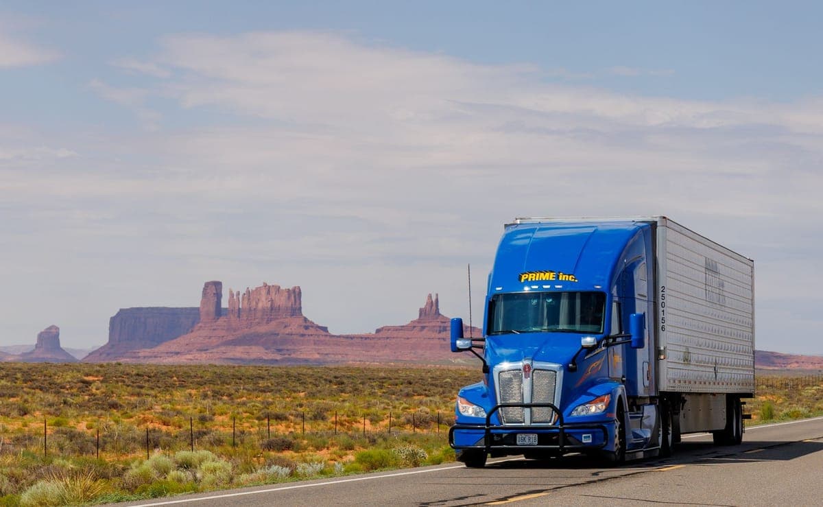 A truck traveling on a desert highway