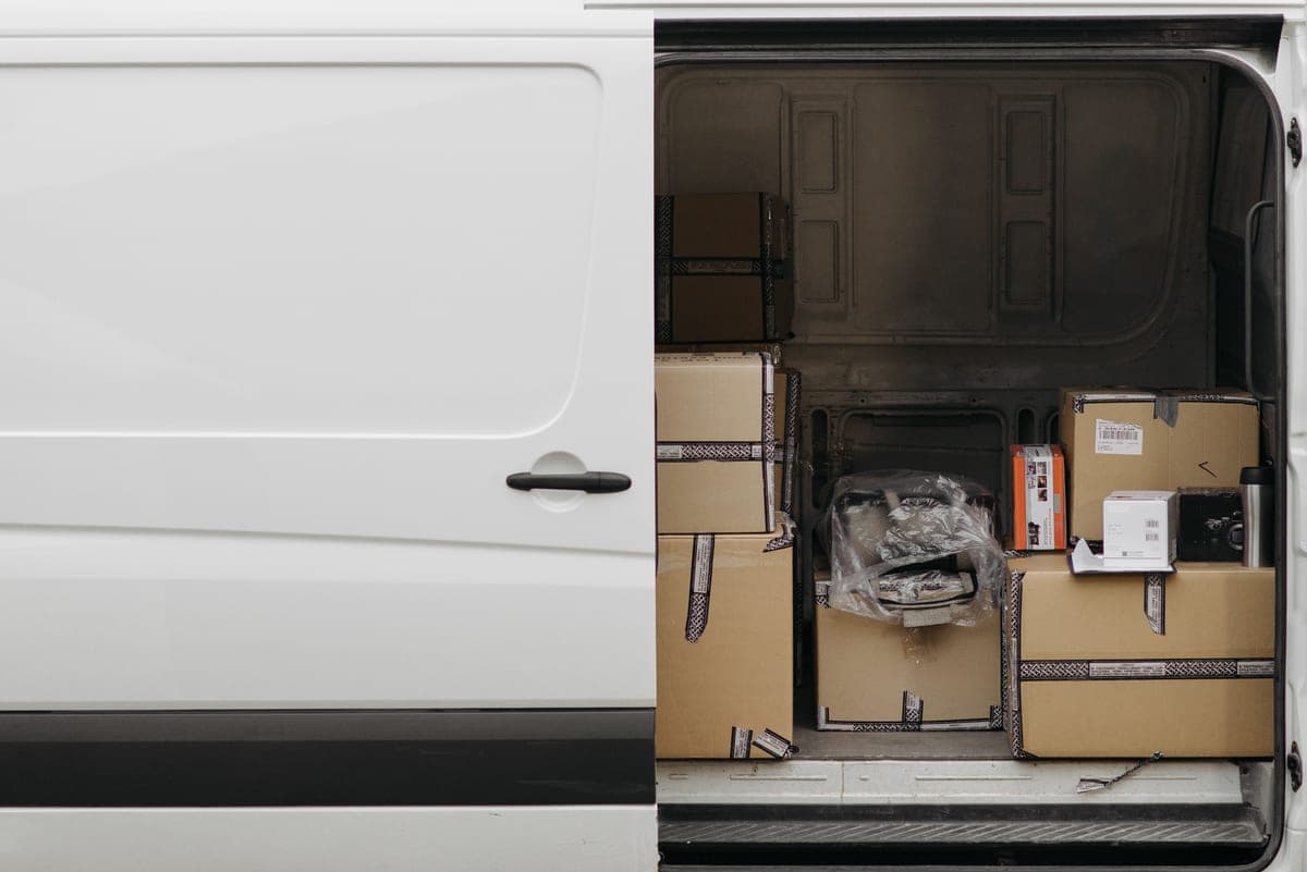 An SUV cargo area with storage boxes and bags