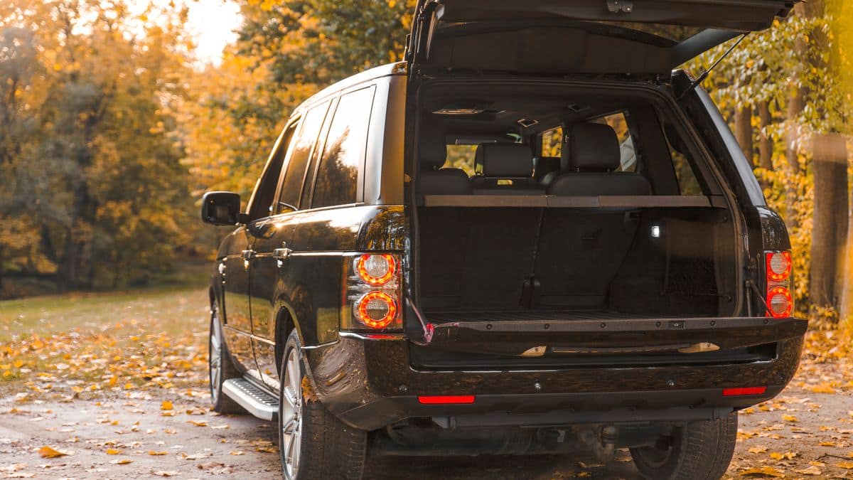 A black SUV with its tailgate open and the cargo area empty