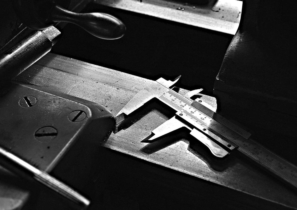 A metal measuring caliper tool