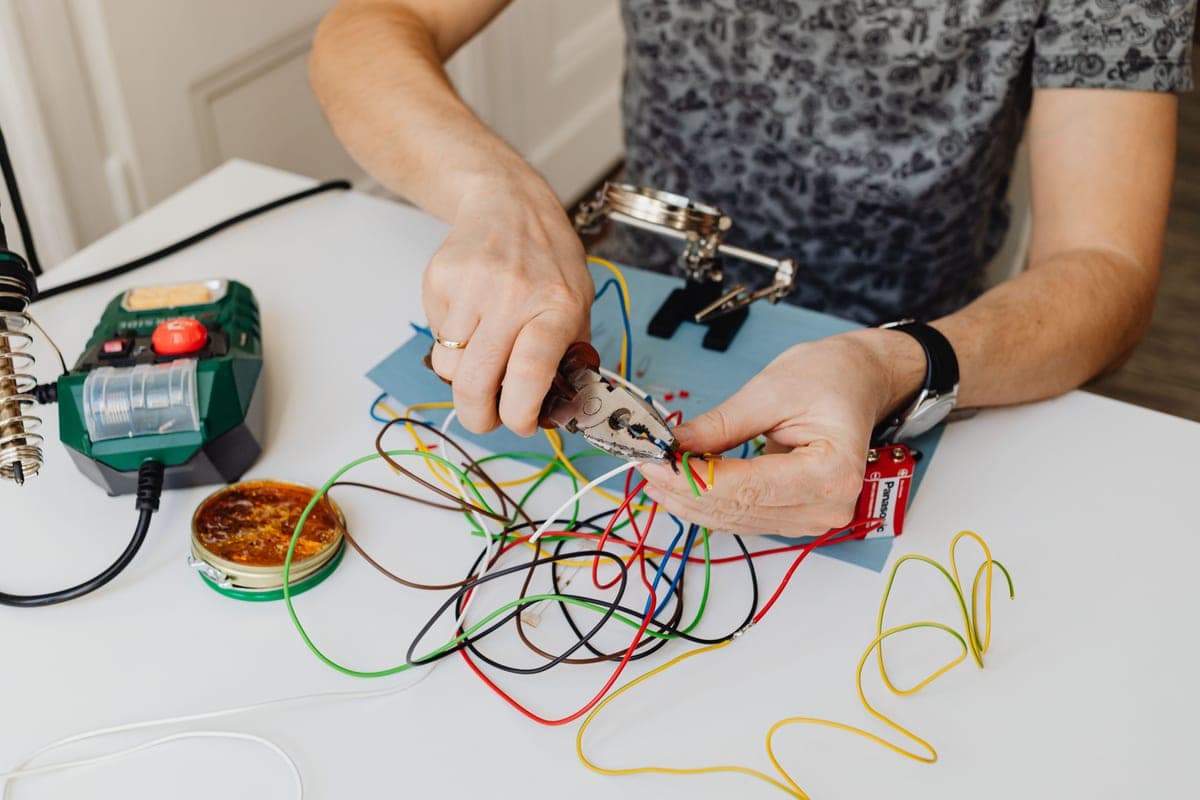 A car electrician working on vehicle wiring