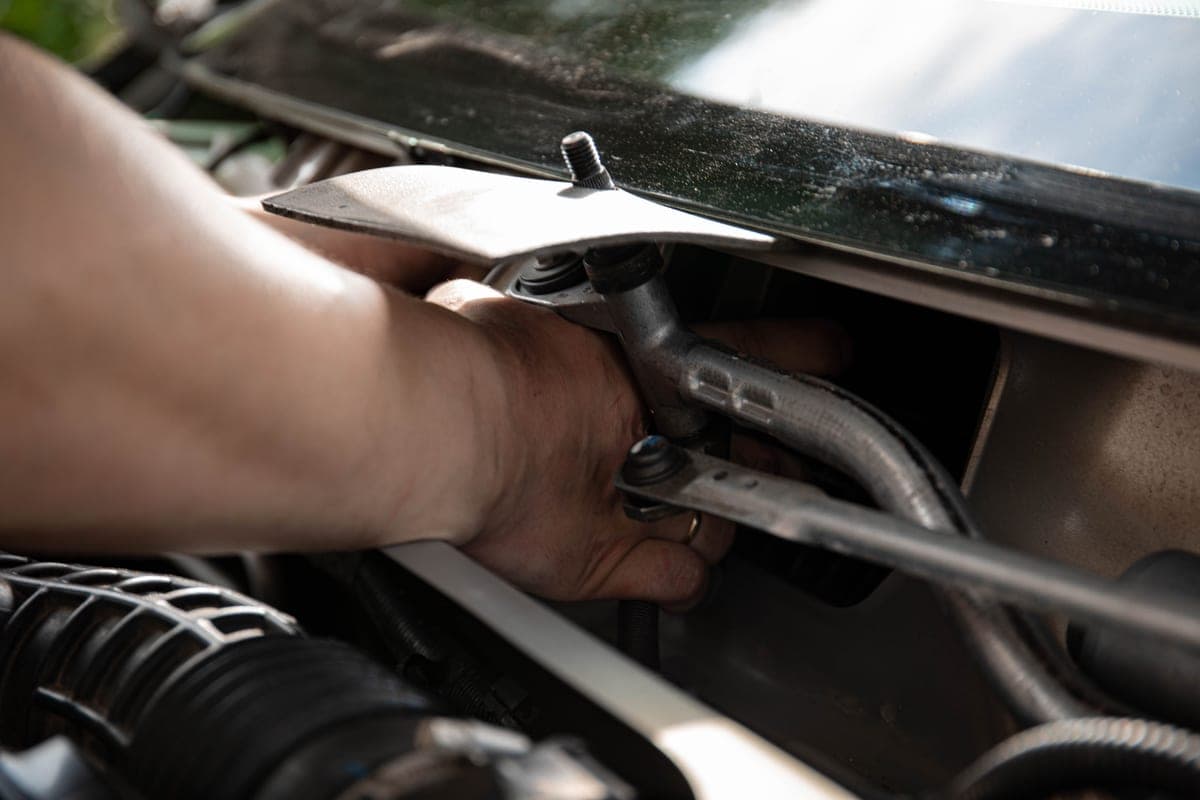 Hands installing a device inside a car