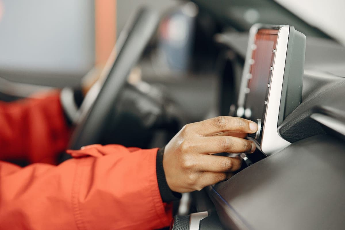 Hands adjusting a car seat interior