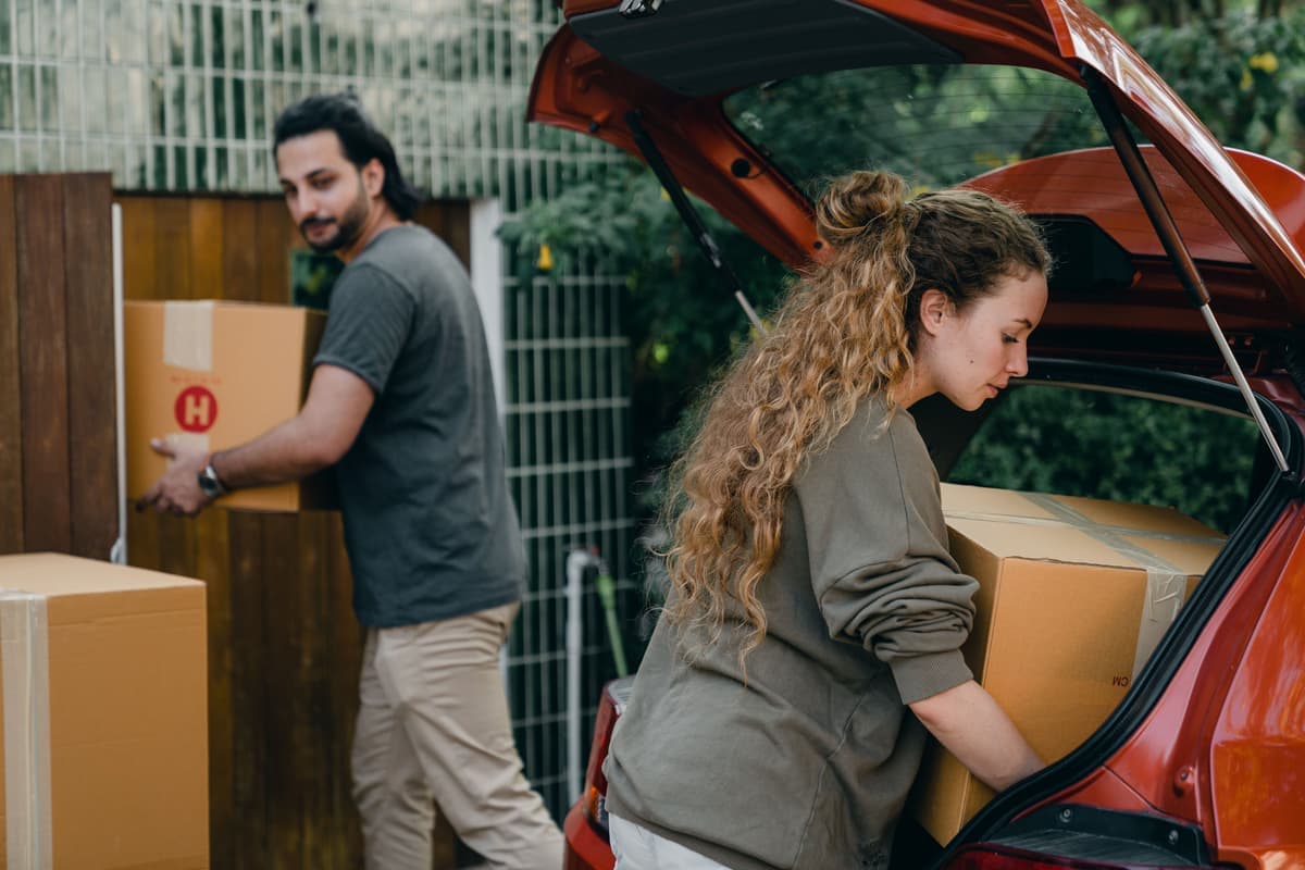 An organized car boot with storage boxes