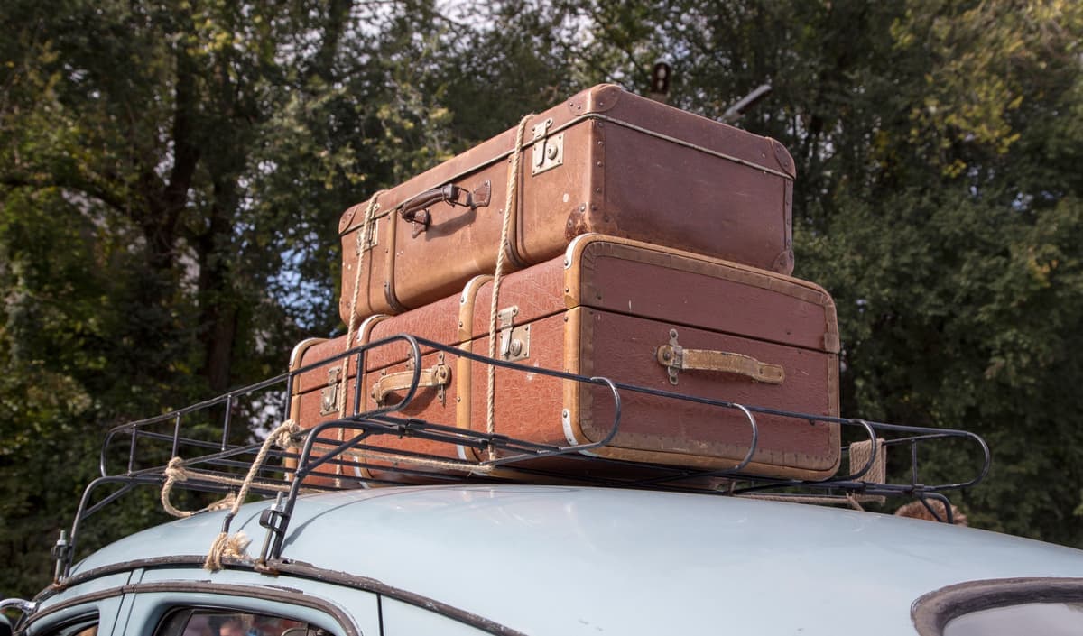 Suitcases packed into a car for a trip