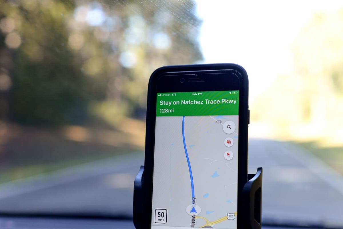 A smartphone showing a navigation route while driving