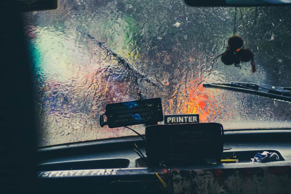 The view through a rain-covered car windshield