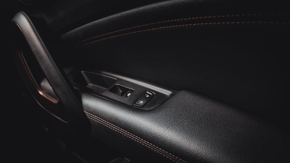 Close-up of a car seat side panel and console