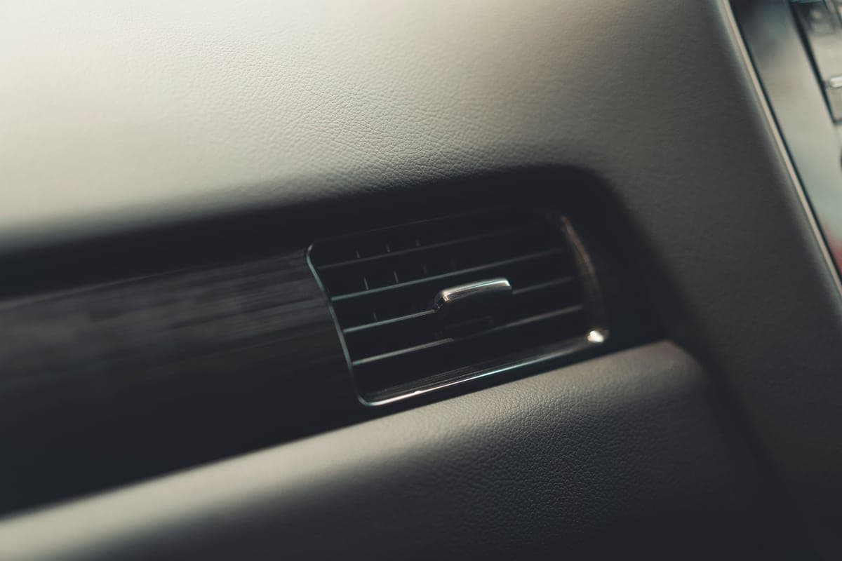 A car air vent and dashboard close up