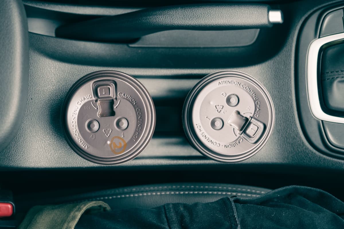 A coffee cup sitting in a car cup holder