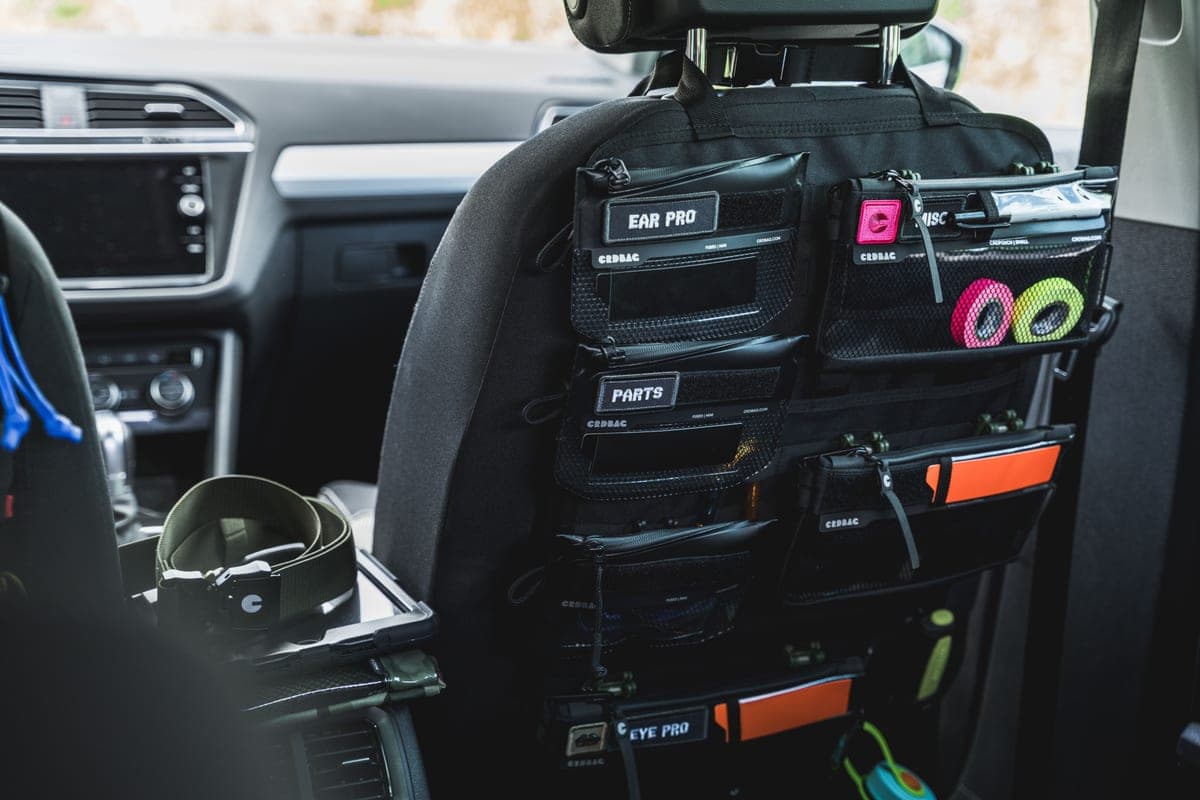 A person tidying and organizing the interior of a car