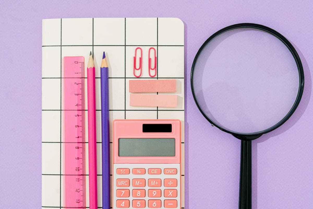 A notebook, calculator and measurements on a desk